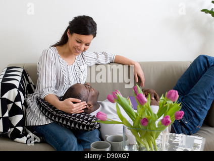 Couple relaxing on sofa Stock Photo