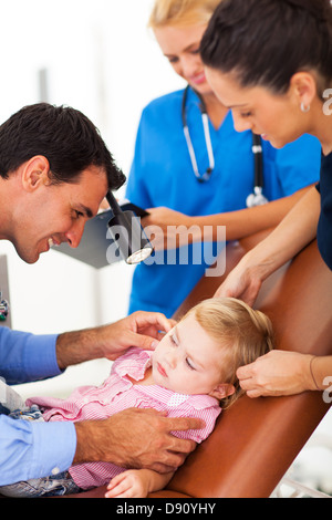 friendly pediatrician examining litlle girl's ear Stock Photo