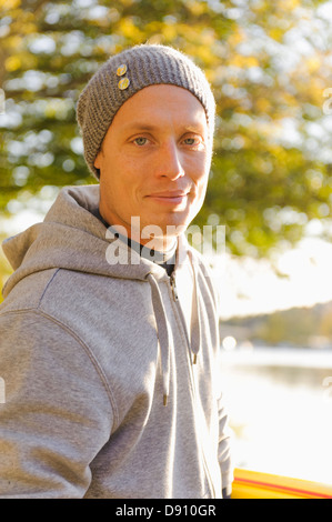 Man in knit cap smiling outdoors Stock Photo