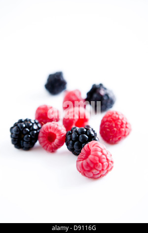 Raspberries and blackberries on white background Stock Photo - Alamy