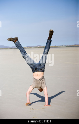 Man doing handstand Stock Photo