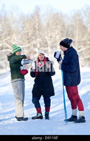 Three people cross country skiing and having coffee Stock Photo