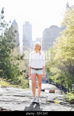 Young woman posing with skyscrapers in background Stock Photo