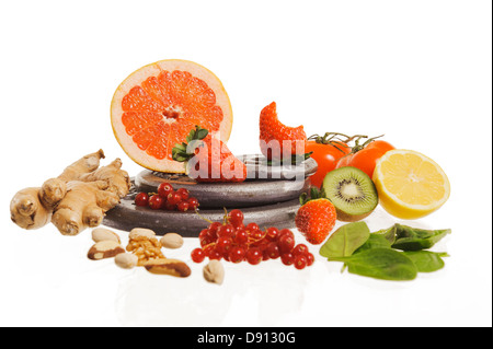Various fruits and vegetables on weights, studio shot Stock Photo