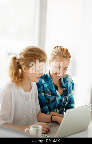 Two young women working on laptop Stock Photo