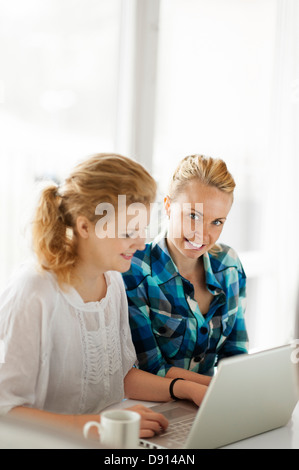 Two young women working on laptop Stock Photo