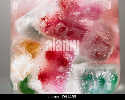 Ice cubes with coloured fruits. Stock Photo