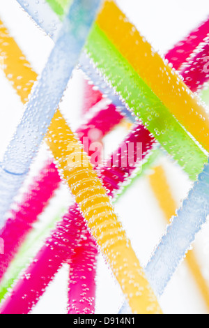 Studio shot of colorful drinking straws in water