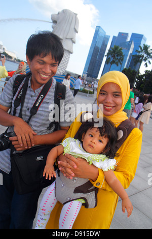 Singapore,Singapore River water,Marina Bay water,Merlion Park,Asian Asians ethnic immigrant immigrants minority,adult adults man men male,woman women Stock Photo