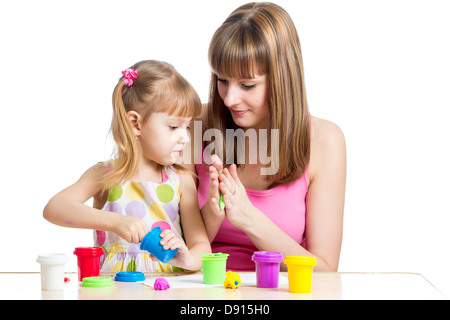 kid girl and mother playing colorful clay toy Stock Photo