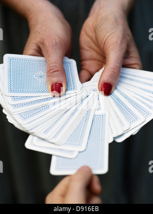 Hands holding fanned out playing cards Stock Photo