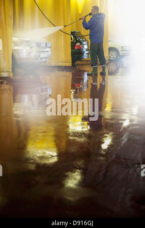 Man washing car in carwash Stock Photo