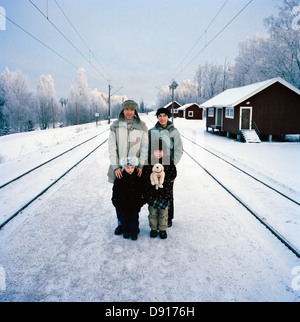 A family standing on a railway station, Dalarna, Sweden. Stock Photo