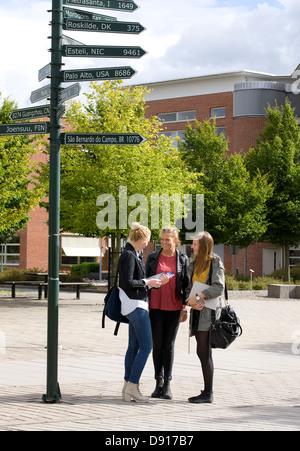 Students outside university building Stock Photo