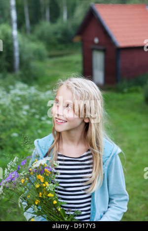 Portrait of girl holding buttercups Stock Photo