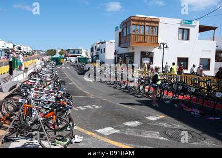 Rows of Triathlon Competitors Bicycles in Racks Stock Photo