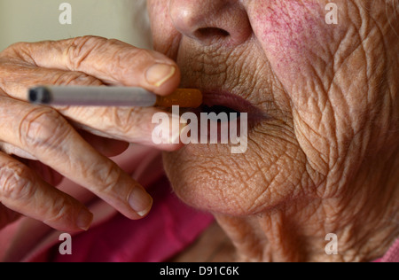 Old woman smoking, elderly woman smoker with a cigarette, elderly lady smoking Stock Photo