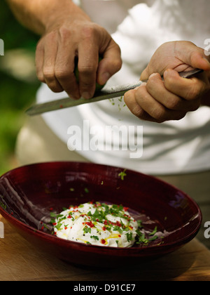 Man making a sauce with grated lime, Sweden.