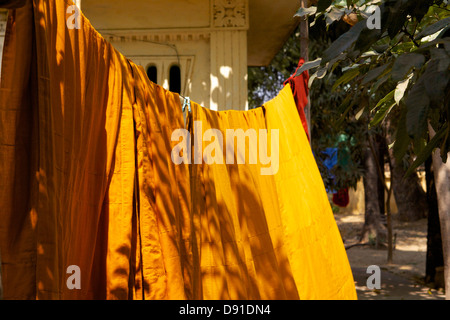 Monks' saffron robes washed hung out to dry in the sun at the Shwe In Bin Kyaung monastery in Mandalay Stock Photo