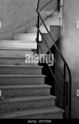 Dirty marble staircase in abandoned interior. Architectural detail, black and white. Stock Photo