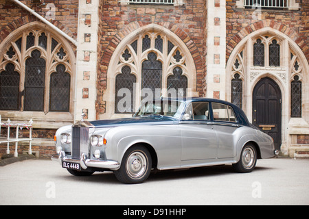1964 Rolls Royce Silver Cloud III 3 four door saloon outdoors in front of an old building in two tone silver and blue. Stock Photo