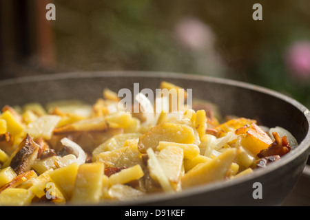 fried potatoes with onions in a frying pan Stock Photo