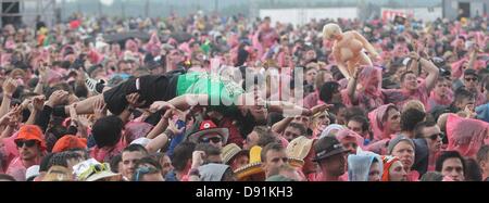 Nuerburg, Germany. 8th June, 2013. Audiences cheer and crowd-surf during the concert of Australian rock band Airbourne in the rain in front of the main stage of rock festival 'Rock am Ring' in Nuerburg, Germany, 08 June 2013. Tickets for the three-day event were sold out long ago. Photo: THOMAS FREY/dpa/Alamy Live News Stock Photo