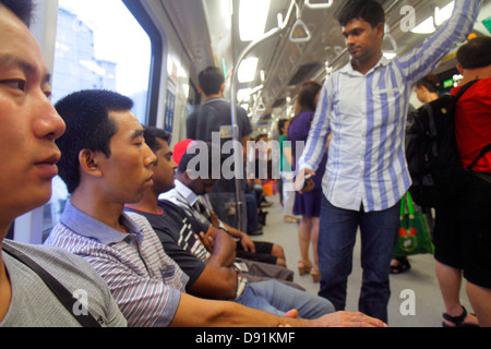 Singapore MRT East West Line,subway train,passenger cabin,riders,commuters,Asian man men male,sitting,standing,Sing130203173 Stock Photo