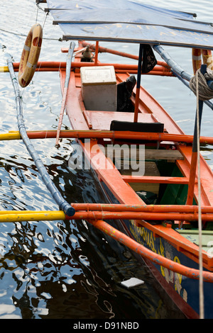 Traditional Outrigger Boat in Manila Bay, Philippines Stock Photo