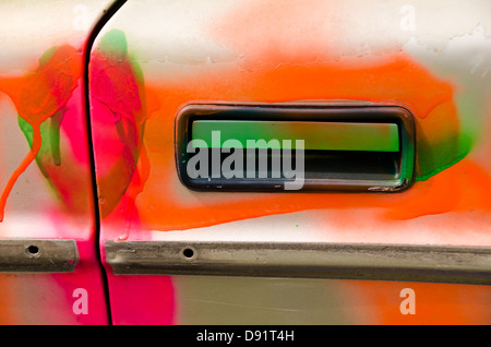 Door handle of an old car painted in psychedelic colors Stock Photo