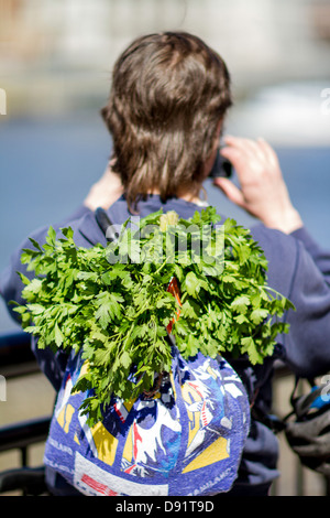 Man with fresh herbs in his rucksack, London, United Kingdom Stock Photo