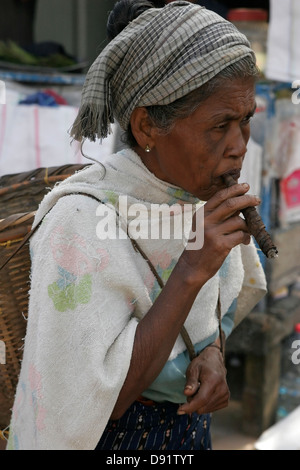 Tribal woman smoking cigar, Rangamati market, Chittagong Hill Tracts, Bangladesh Stock Photo