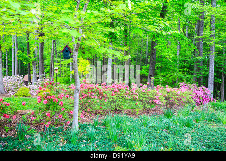 Hand crafted birdhouse in a manicured garden. North Carolina Stock Photo