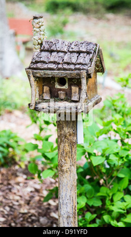 Hand crafted birdhouse in a manicured garden. North Carolina Stock Photo