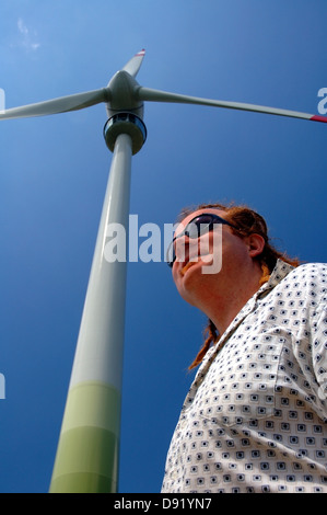 Wind turbine engineer with Enercon wind turbine in background Stock Photo