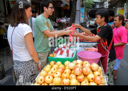 Thailand,Thai,Bangkok,Silom,Silom Road,street,vendor vendors,stall stalls booth market,pomegranate,fruit juices,drink drinks,food,Asian man men male,j Stock Photo