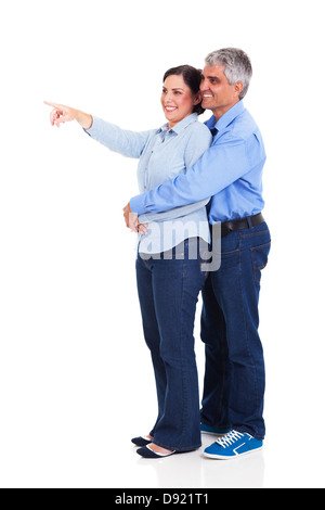 mature woman pointing at copyspace with her husband isolated on white background Stock Photo