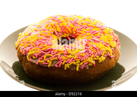 Sprinkle donut on plate Stock Photo