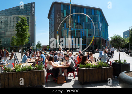 People dining al fresco in summer sunshine at Jamie Oliver Italian Restaurant by John Lewis & Library Cardiff City Centre Wales UK  KATHY DEWITT Stock Photo