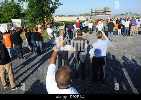 Governors Island, NY, US. 9 June 2013. Using more than 200 pounds of dynamite, an 11-story building was imploded on Governors Island at 7:36 a.m. on June 9, 2013. It took approximately 10 seconds for the building to be reduced to a pile of rubble. This photo was taken with one minute to go before the implosion. Credit:  Terese Loeb Kreuzer/Alamy Live News Stock Photo