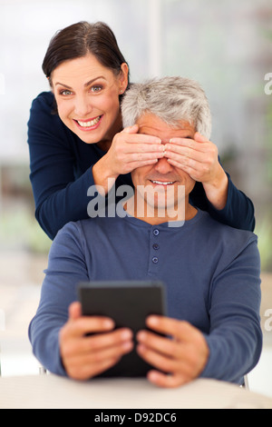 playful middle aged couple having fun at home Stock Photo