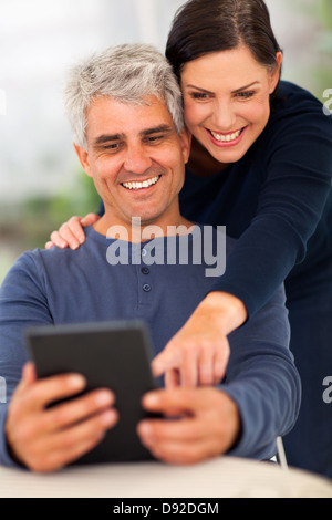 happy senior couple using tablet computer at home Stock Photo