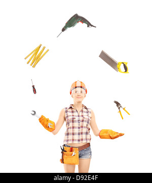 Female manual worker juggling with tools, isolated on white background Stock Photo