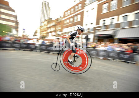 London, UK. 8th June 2013. A rider cornering at speed during the Brooks Penny-Farthing Race. The race took place on the closed streets around Smithfield Market as part of the IG Markets London Nocturne. Credit:  Michael Preston/Alamy Live News Stock Photo