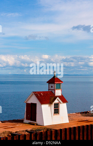 Small red and white lighthouse on wharf at ferry departure point from Wood Islands, PEI to Caribou, Nova Scotia Stock Photo