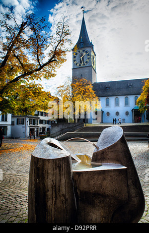 Low Angle View of the Saint Peter's Church, with a Modern Fountain in the Foreground, Zurich, Switzerland Stock Photo