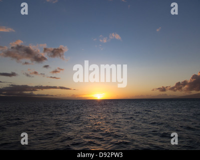 Maui Sunset over the ocean with vast blue skies Stock Photo