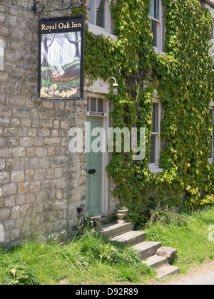 Front door and painted sign at the Royal Oak Inn traditional country pub in Nunnington village North Yorkshire Stock Photo