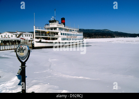 Sightseeing Boat Moored at a Pier in a Frozen Lake, Lake George Village, New York Stock Photo