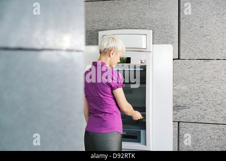 business woman withdrawing cash at bank atm Stock Photo